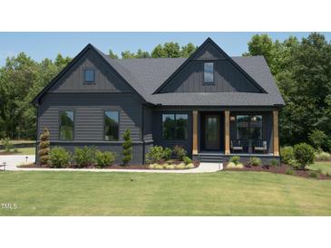 Craftsman style home with dark siding, light trim, and a covered porch at 82 Byrd Ln, Pittsboro, NC 27312