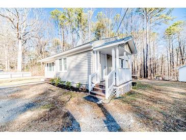 Cute cottage with front porch and wood siding at 902 Cobb Ct, Sanford, NC 27330
