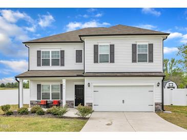 Two-story home featuring a two-car garage, front porch, white siding and black shutters at 108 Bonnie Girl Ct, Lillington, NC 27546