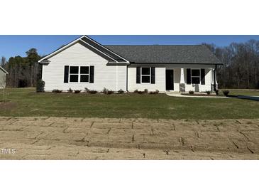 White house with gray roof, landscaping, and stone accents at 148 Phil Jack Rd, Dunn, NC 28334