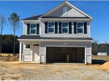 Two-story house with gray siding, black shutters, and a two-car garage at 200 Wild Turkey Way Way, Lillington, NC 27546