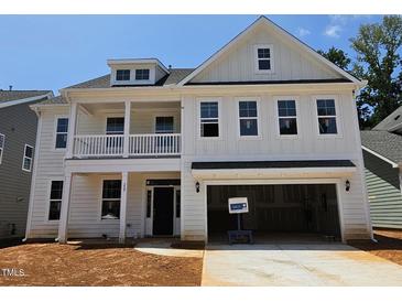 New construction, two-story home boasts a welcoming front porch and attached two-car garage at 227 Augusta Pond Way # 159, Raleigh, NC 27603