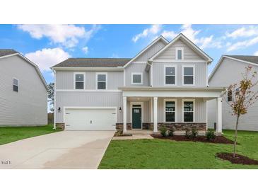 Two story home with gray siding and a welcoming front porch at 317 Umstead St, Sanford, NC 27330