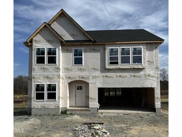 New two-story home boasts black roof, white windows, and a spacious two-car garage at 364 Pecan Valley Way, Four Oaks, NC 27524