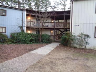 Exterior view of condo building with walkway and landscaping at 626 Pine Ridge Pl Pl, Raleigh, NC 27609