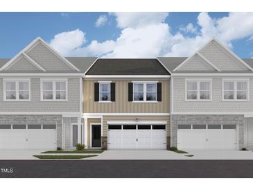 Three-unit townhome building, two-car garage, neutral siding at 7117 Hubner Pl # 22, Cary, NC 27519