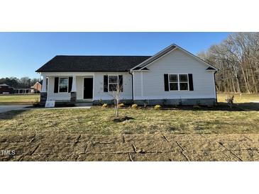 Charming one-story house with vinyl siding, a gray roof, and a small front yard at 93 Faucette Dr, Selma, NC 27576