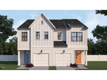 Stunning duplex featuring white siding, black roof, white garage doors, and colorful front doors at 935 Selby Ave, Durham, NC 27713