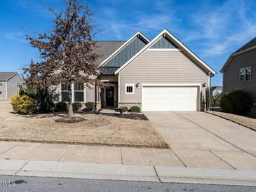 Curb appeal abounds at this charming ranch home featuring a neutral color palette and attached garage at 13 Needham Ln, Clayton, NC 27527