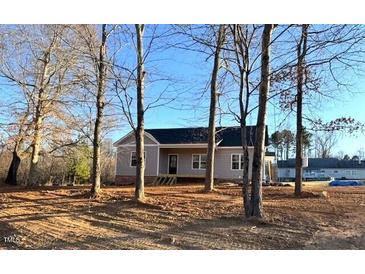 Newly constructed house with gray siding, front porch, and surrounding trees at 170 Squirrel Path Way, Roxboro, NC 27574
