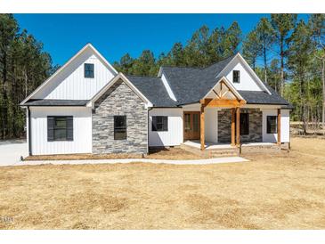 Craftsman style home with white siding, stone accents, and a covered porch at 250 Ellington Rd, Graham, NC 27253