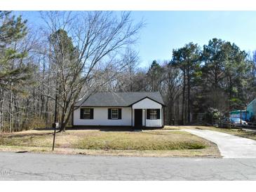 White house with black shutters, front yard, and driveway at 2500 Sundial Cir, Durham, NC 27704