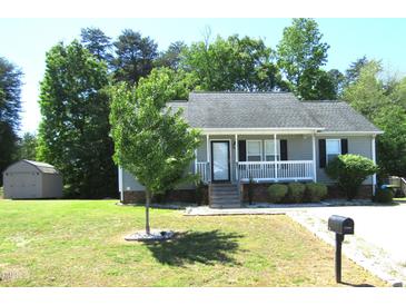 Charming single-story home with a well-maintained lawn and inviting front porch at 409 James Toney Dr, Elon, NC 27244