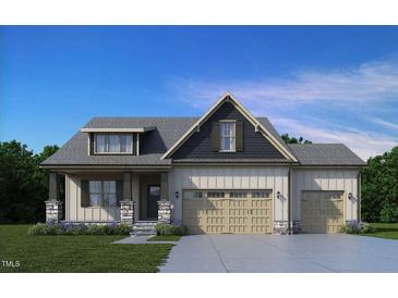 Two-story house with a three-car garage, stone accents, and a landscaped yard at 152 Boyce Ct, Sanford, NC 27332