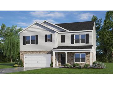 Two-story home with gray siding, brick accents, and a two-car garage at 197 Paper Birch Way, Fuquay Varina, NC 27526