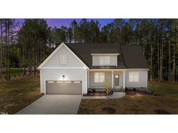 Charming single-Gathering home featuring a two-car garage and a meticulously maintained lawn with mature landscaping at 50 Arbor Dr, Youngsville, NC 27596