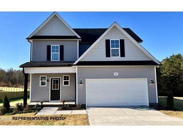 Two-story house with gray siding, black accents, and a two-car garage at 209 Danube Dr, Zebulon, NC 27597