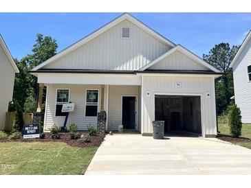 Charming single-story home with a one-car garage, quaint porch, and fresh landscaping at 356 Maidenhair Pl, Clayton, NC 27520
