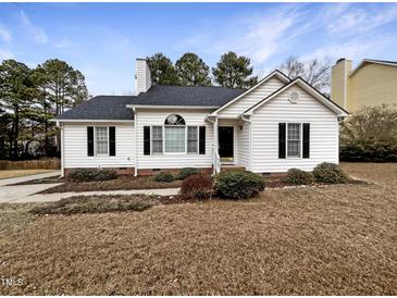 White house with landscaping, walkway, and a neatly kept lawn at 4109 Mangrove Dr, Raleigh, NC 27616