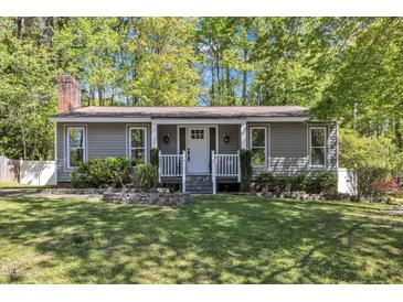 Charming home featuring a manicured front yard and a cozy front porch at 1304 Rothes Rd, Cary, NC 27511