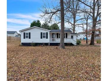 Charming single-story home with black shutters and a cozy front porch at 2400 Dorety Pl, Raleigh, NC 27604