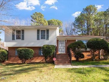 Charming two-story home featuring a well-maintained lawn and mature landscaping at 2509 Foxgate Dr, Raleigh, NC 27610