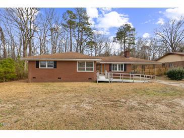 Brick ranch house with ramp access and a spacious yard at 1113 W Mount Dr, Rocky Mount, NC 27803