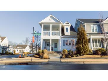 Two-story home with white siding, front porch, and landscaping at 1584 Rhodeschool Dr, Wendell, NC 27591