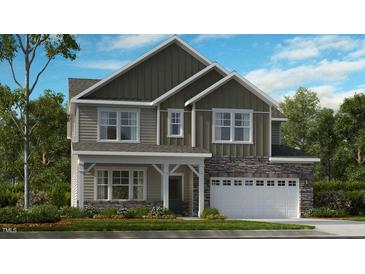 Two-story home with stone accents and a two-car garage at 246 Tidal Pool Way, Cary, NC 27519