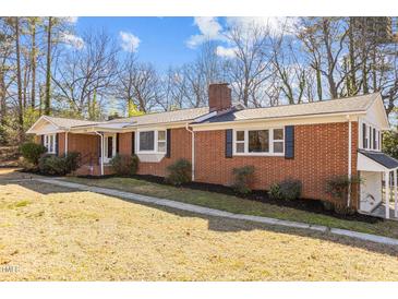 Brick ranch house with mature landscaping and a spacious lawn at 420 Nelson St, Durham, NC 27707