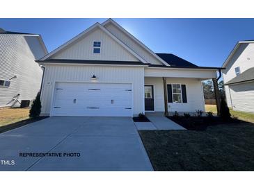 Craftsman style home with white siding, two-car garage, and landscaping at 59 Pretty Run Branch Ln, Wendell, NC 27591