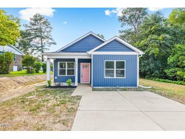 Charming home with blue siding, white trim, pink front door, and a concrete driveway at 0 Cedar Grove Church Rd Rd, Roxboro, NC 27574