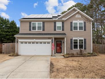 Charming two-story home with a two-car garage and solar panels on the roof at 12420 Tetons Ct, Durham, NC 27703
