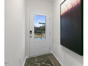 Bright entryway with a modern door and stylish wall art at 1316 White Verona Way, Knightdale, NC 27545