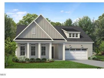 Two-story home with gray siding, white columns, and a two-car garage at 213 Mugby Rd # 171, Raleigh, NC 27610