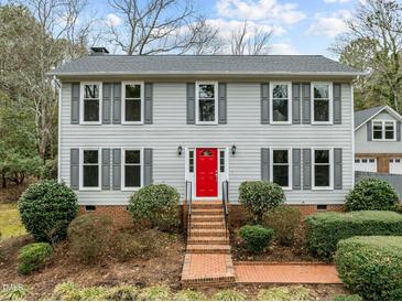 Two story house with gray siding, red door, and brick walkway at 4532 Malvern Rd, Durham, NC 27707