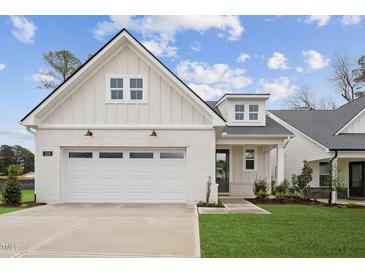 Beautiful craftsman-style home with a light brick facade, two-car garage, and well-manicured lawn at 528 Gainer Dr # 8, Raleigh, NC 27610