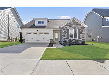 Charming single-Gathering home featuring stone accents, a two-car garage, and a well-manicured lawn at 612 Sweet Pine Ln, Knightdale, NC 27545