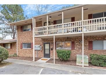 Charming brick townhouse featuring a covered balcony and well-maintained landscaping at 130 S Estes Dr # G3, Chapel Hill, NC 27514