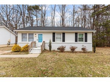 Charming one-story home with a blue front door and well-maintained landscaping at 200 Westbury Dr, Oxford, NC 27565
