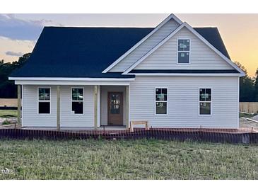 Charming single-story home with a covered porch and black roof ready for new owner at 3963 Baileys Xrds Rd, Benson, NC 27504