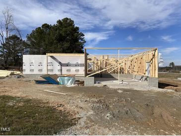 Image of new home under construction with wood framing, sheathing, and concrete block foundation on a sunny day at 47 Royal Ave, Selma, NC 27576