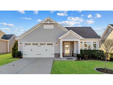 Charming single-story home boasts a two-car garage and well-maintained landscaping at 65 Balsam Ln, Clayton, NC 27527
