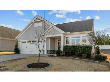 Charming home with a two-car garage, well-kept lawn and front shrubs at 65 Balsam Ln, Clayton, NC 27527