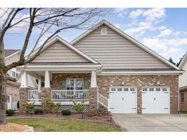 Charming single-story brick home features a cozy front porch and a two-car garage at 812 Canyoncreek Ln, Fuquay Varina, NC 27526