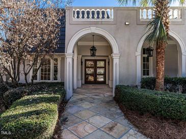 Elegant front entrance with arched entryway, detailed trim, and a stylish hanging lantern at 101 Rutherglen Dr, Cary, NC 27511