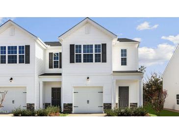 Charming townhome with a one-car garage and a classic white facade at 204 Starlight St, Sanford, NC 27330