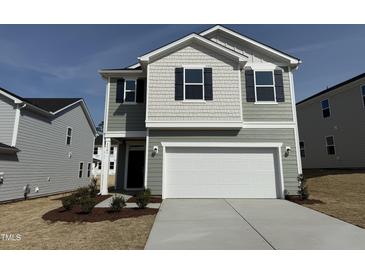 Charming two-story home featuring a two-car garage, beautiful landscaping, and modern architectural details at 2701 Princess Tree Dr, Raleigh, NC 27616