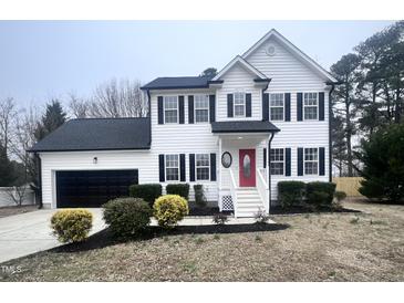 Beautiful two-story home with black shutters, a red door and a well manicured lawn at 3 Azzi Ct, Durham, NC 27703