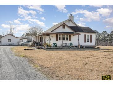 Charming home featuring a covered front porch and spacious front yard at 3158 Us Highway 70 Bus E, Smithfield, NC 27577